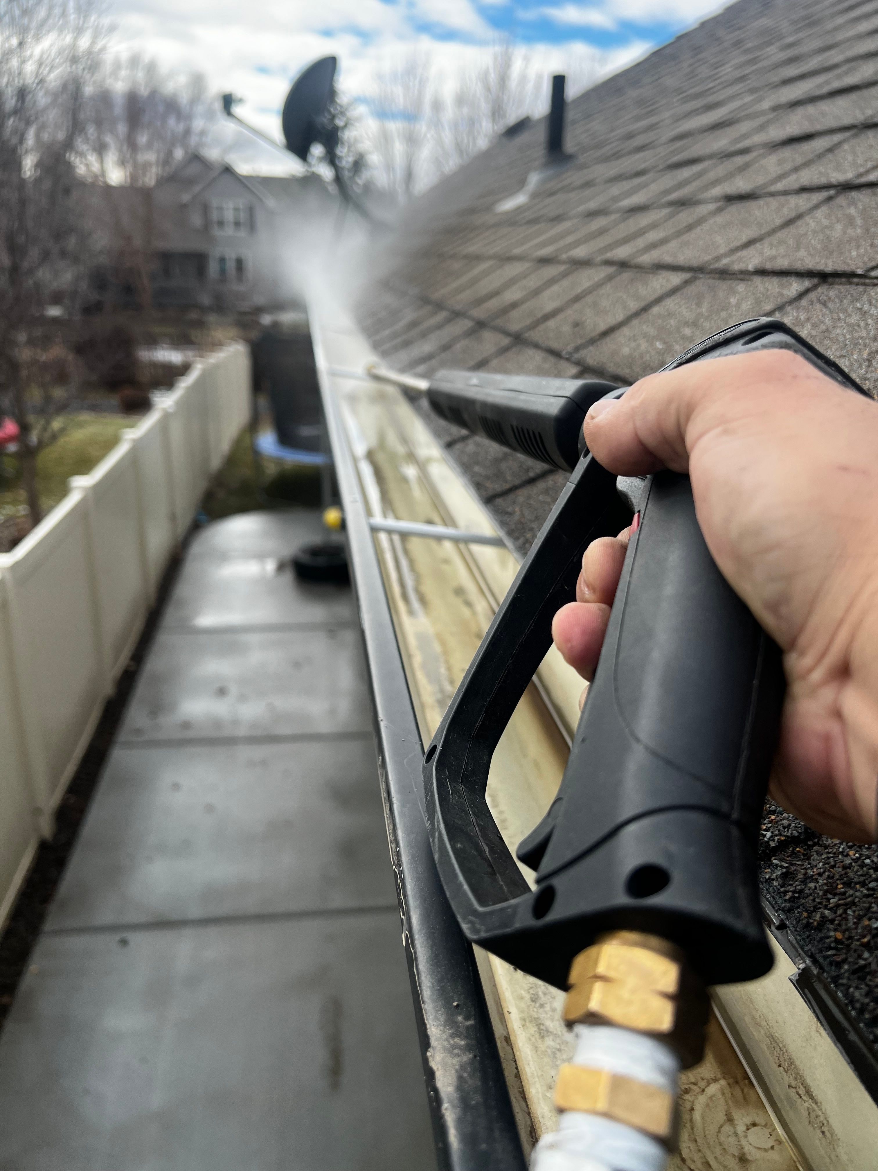Low pressure soft washing of gutters and siding